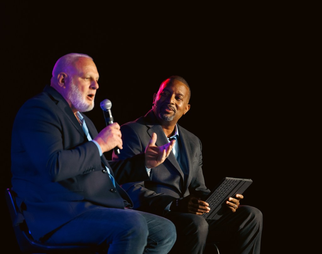 Tyrone Tompkins, CEO Batho Pele Resource Center interviews Principal J. Metcalf of Eisenhower Sr. High School during Multiplied fundraiser vision event.
